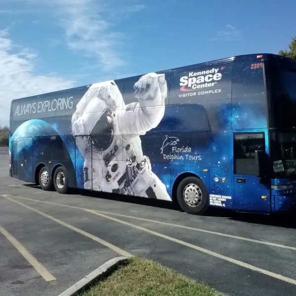 a blue bus parked on the side of a road