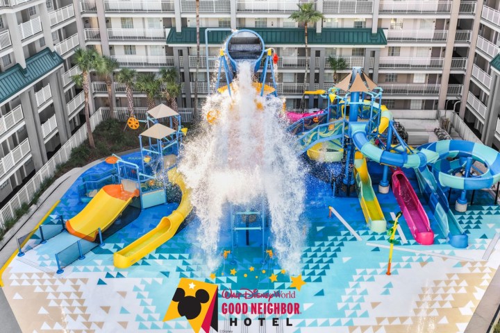 Hotel courtyard with large water playground and colorful slides.