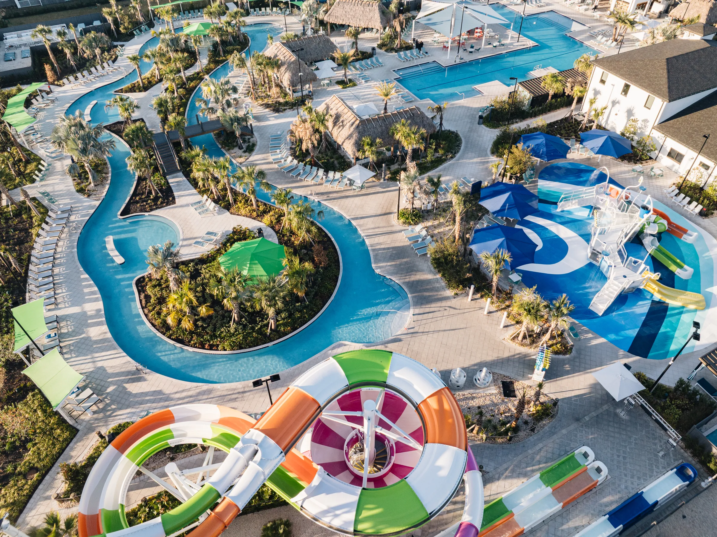 Aerial view of a water park with slides, a lazy river, and pools.